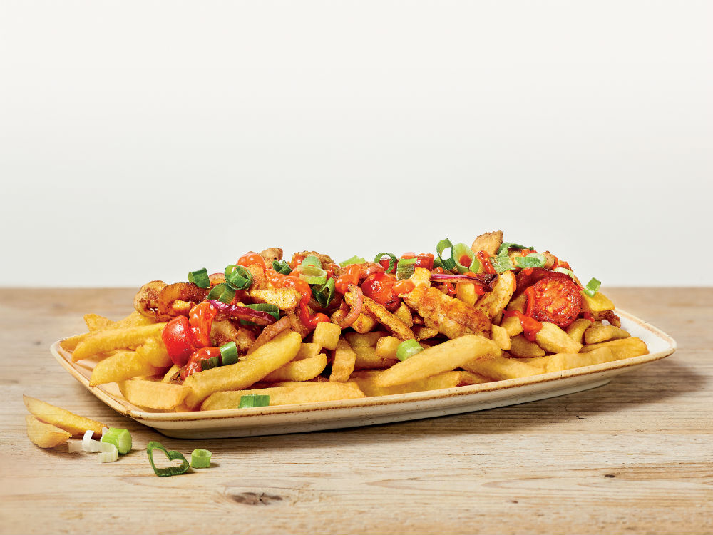 Friet met kip kerriereepjes, pittige paprikasaus, bosui, rode ui en cherrytomaatjes